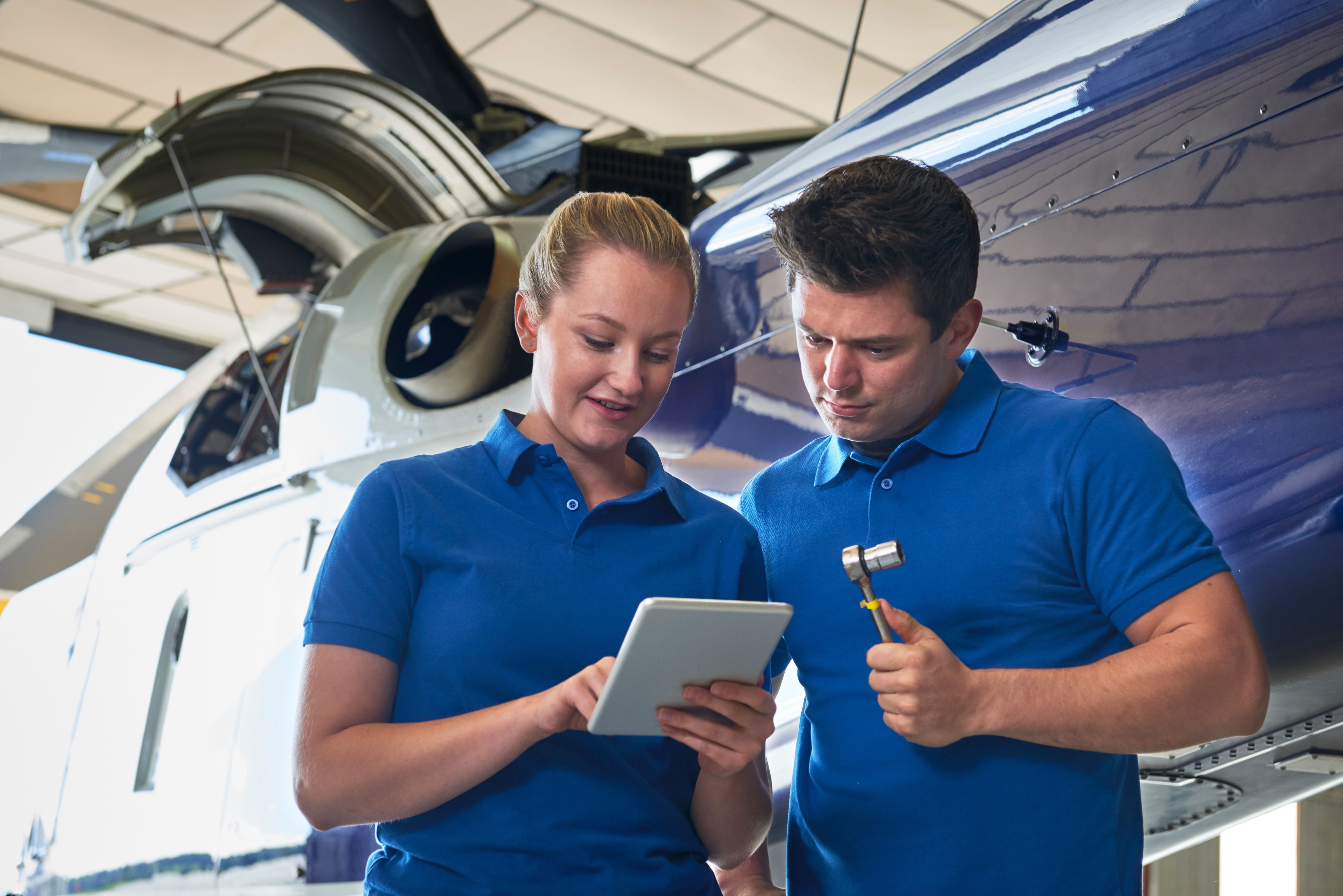 Two engineers looking at a tablet