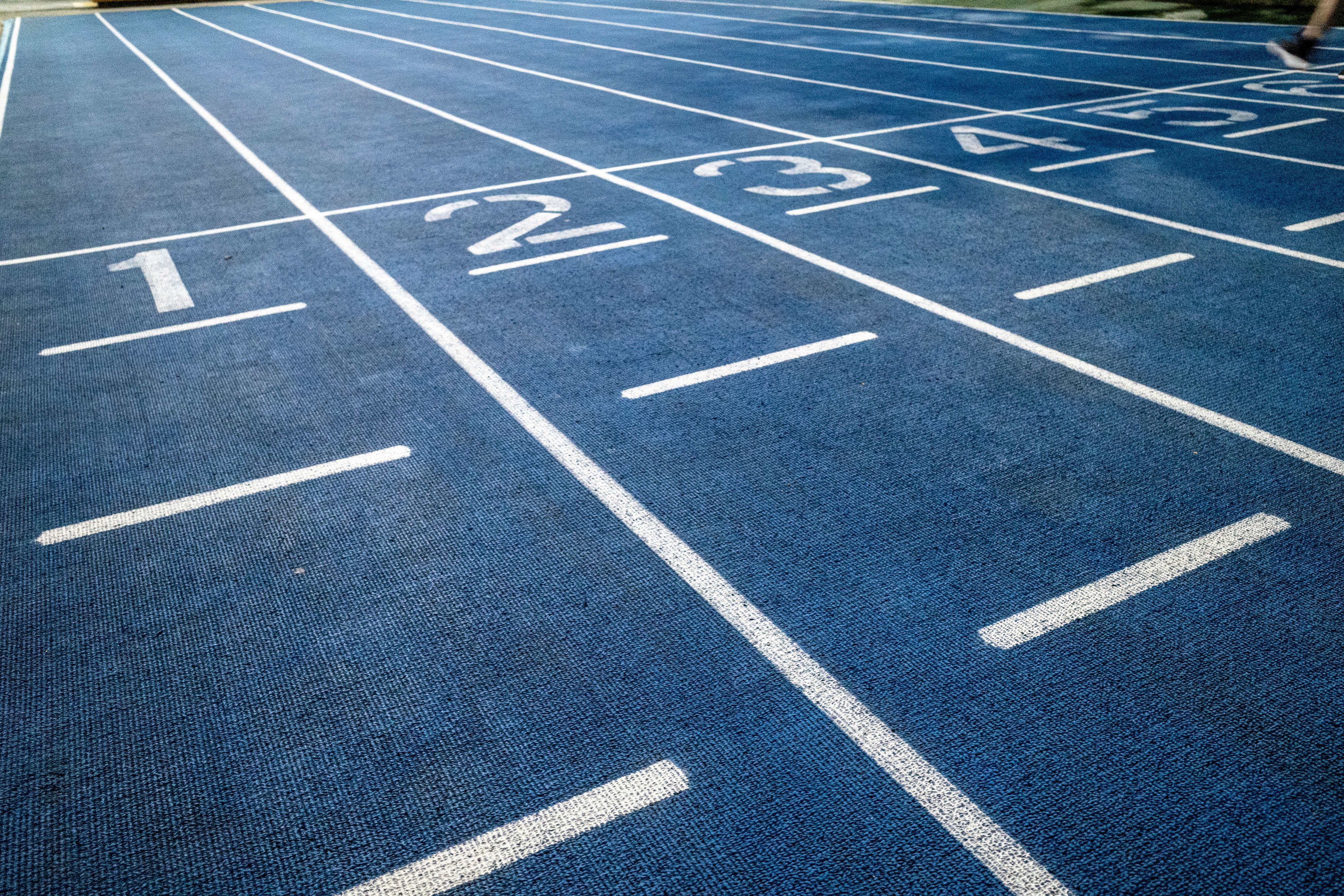 a blue track with white arrows